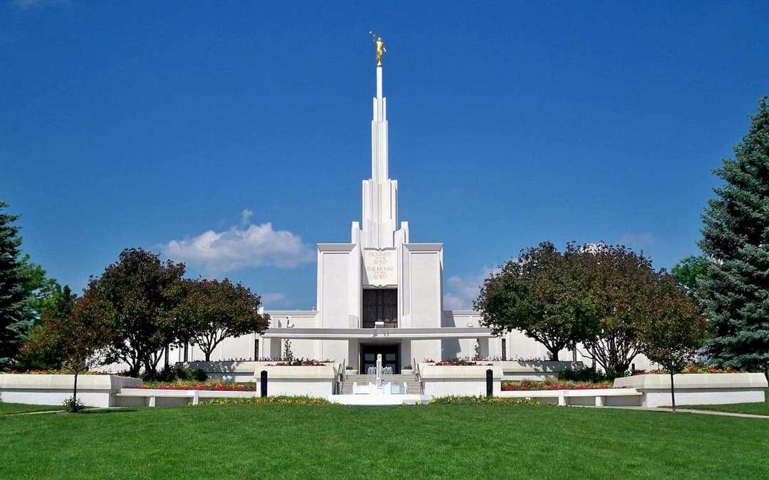 The temple grounds with manicured landscaping and the Rocky Mountain Front Range in the background.