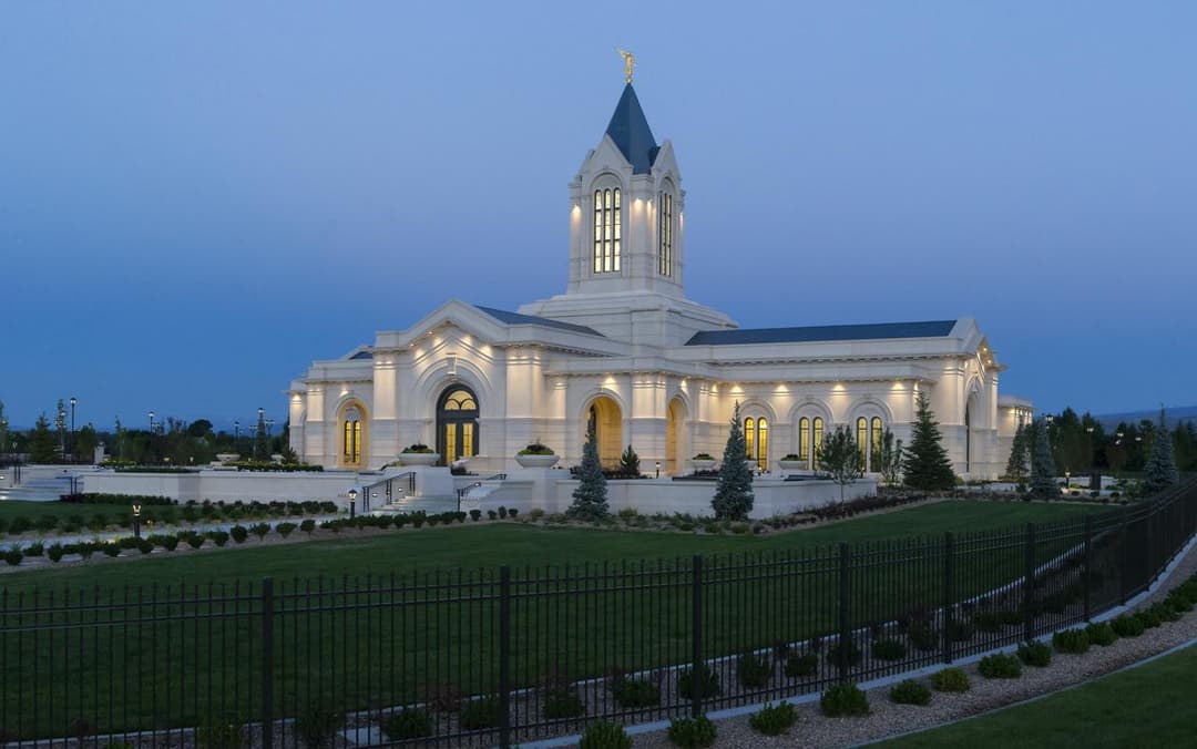 Fort Collins Colorado Temple exterior at twilight with illuminated spire.