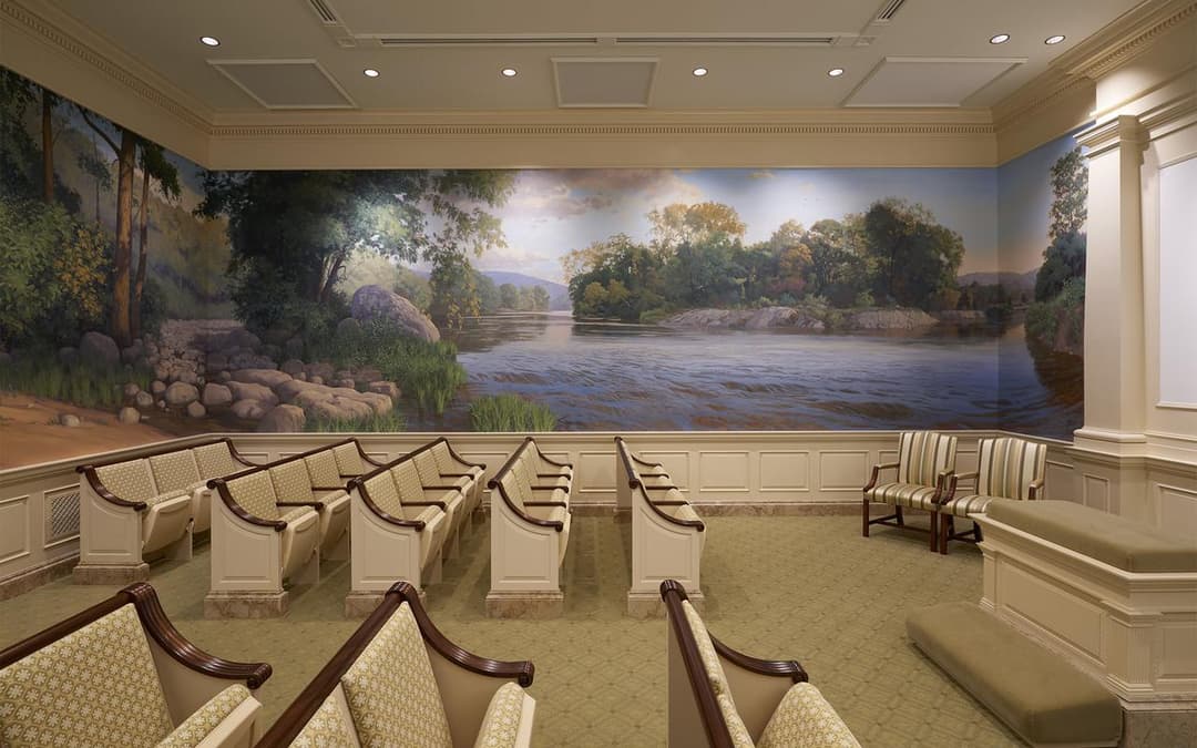 Interior of Hartford CT Temple with a river mural and rows of benches.