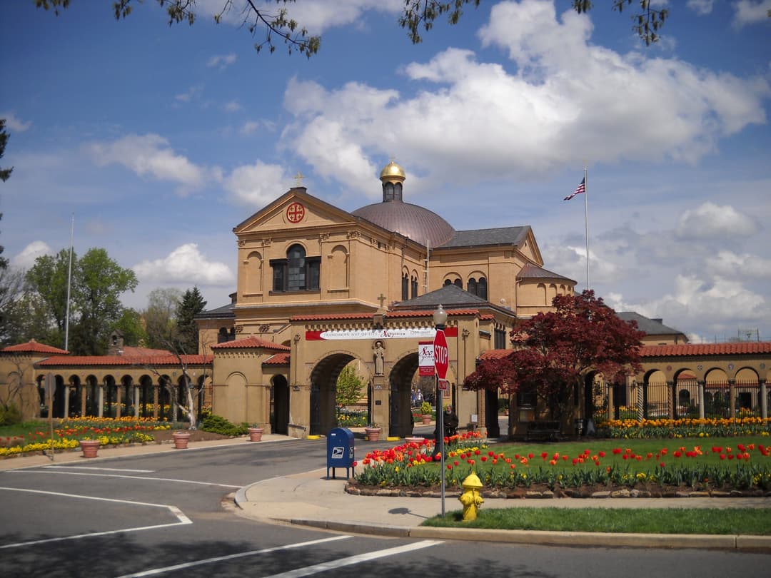 Front exterior view of the entrance gateway, central dome, and tulip gardens.