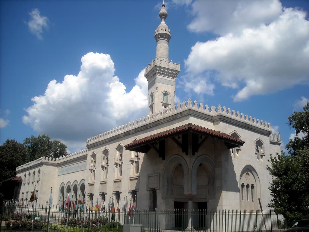 Low-angle exterior view of the Islamic Center's facade and minaret.
