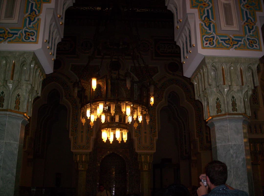Interior view featuring an ornate illuminated chandelier in the prayer hall.