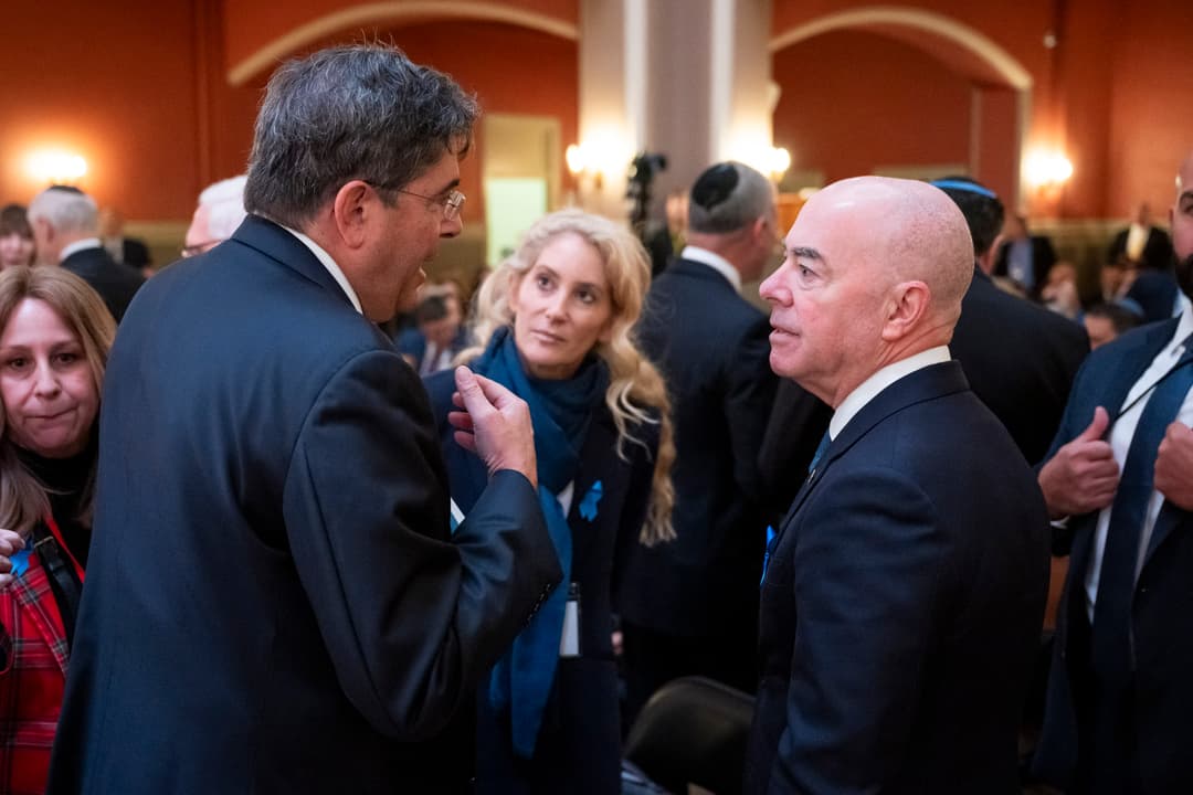 Attendees conversing during an event inside Sixth & I Historic Synagogue.