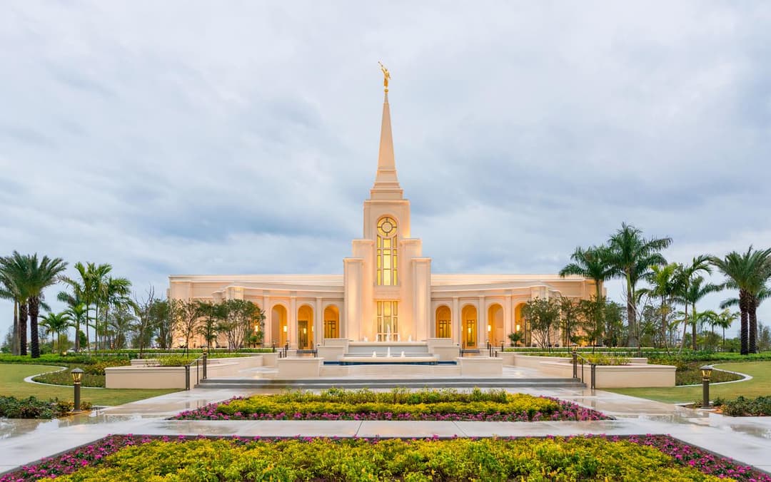 Fort Lauderdale Florida Temple at twilight, with illuminated spire and gardens.