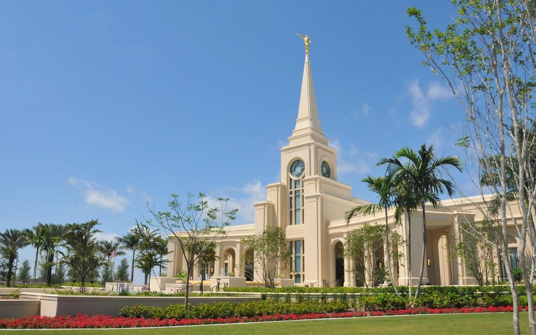 Daytime exterior of Fort Lauderdale Florida Temple with spire and gardens.