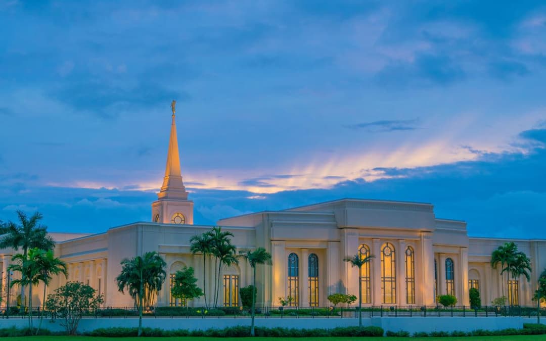 Fort Lauderdale Florida Temple at dusk, with illuminated spire and windows.