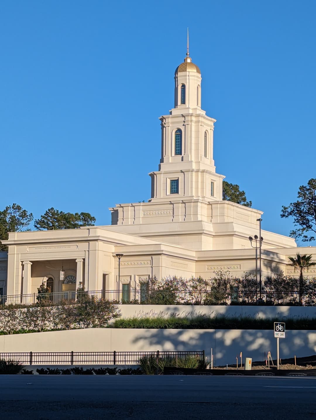 Exterior view of the Tallahassee Florida Temple under a clear blue sky.