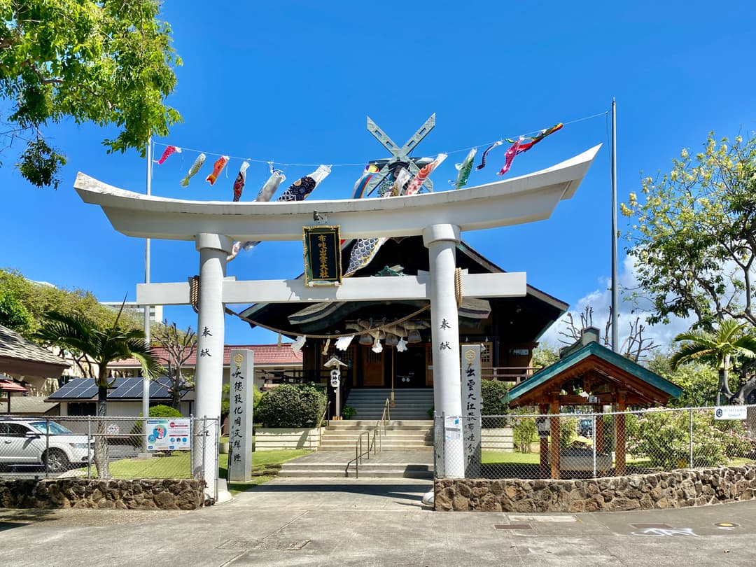 Front entrance view of the torii gate adorned with koinobori streamers