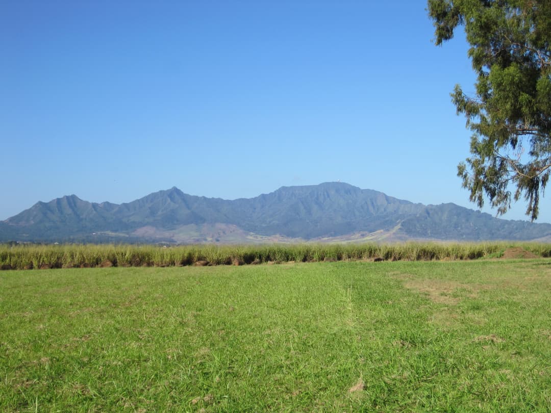 Wide landscape view of the grounds facing the Waiʻanae Mountain Range.