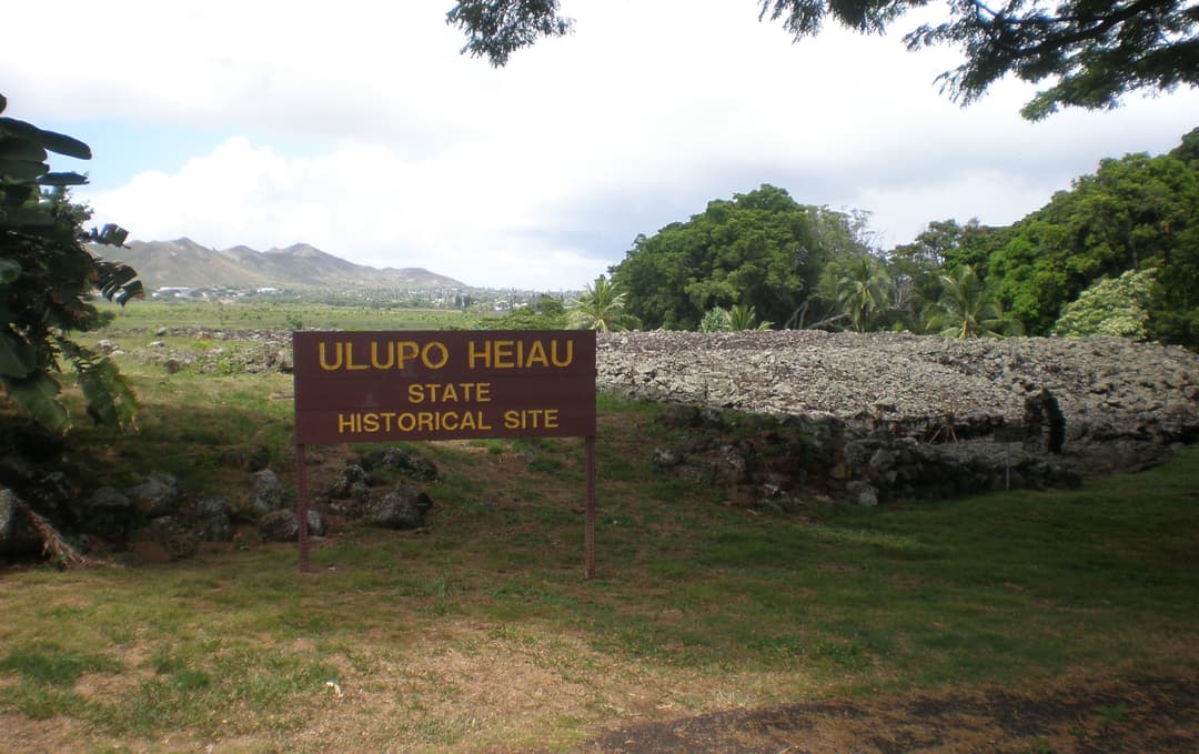 Entrance sign and dry-stone platform at Ulupo Heiau State Historical Site.