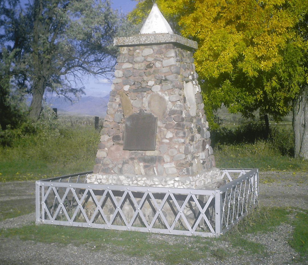 Daytime view of the historic stone monument on the memorial grounds.