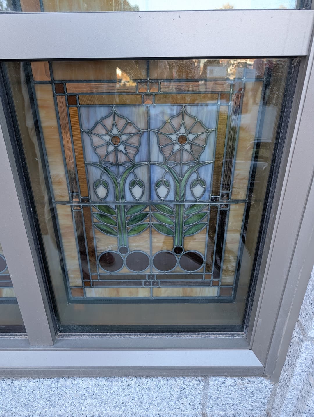 Detail of a stylized floral stained-glass window.