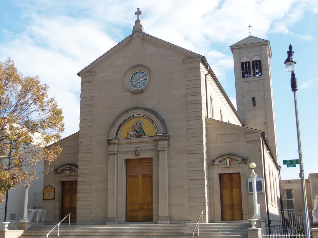 Front entrance and bell tower of the church on a sunny day