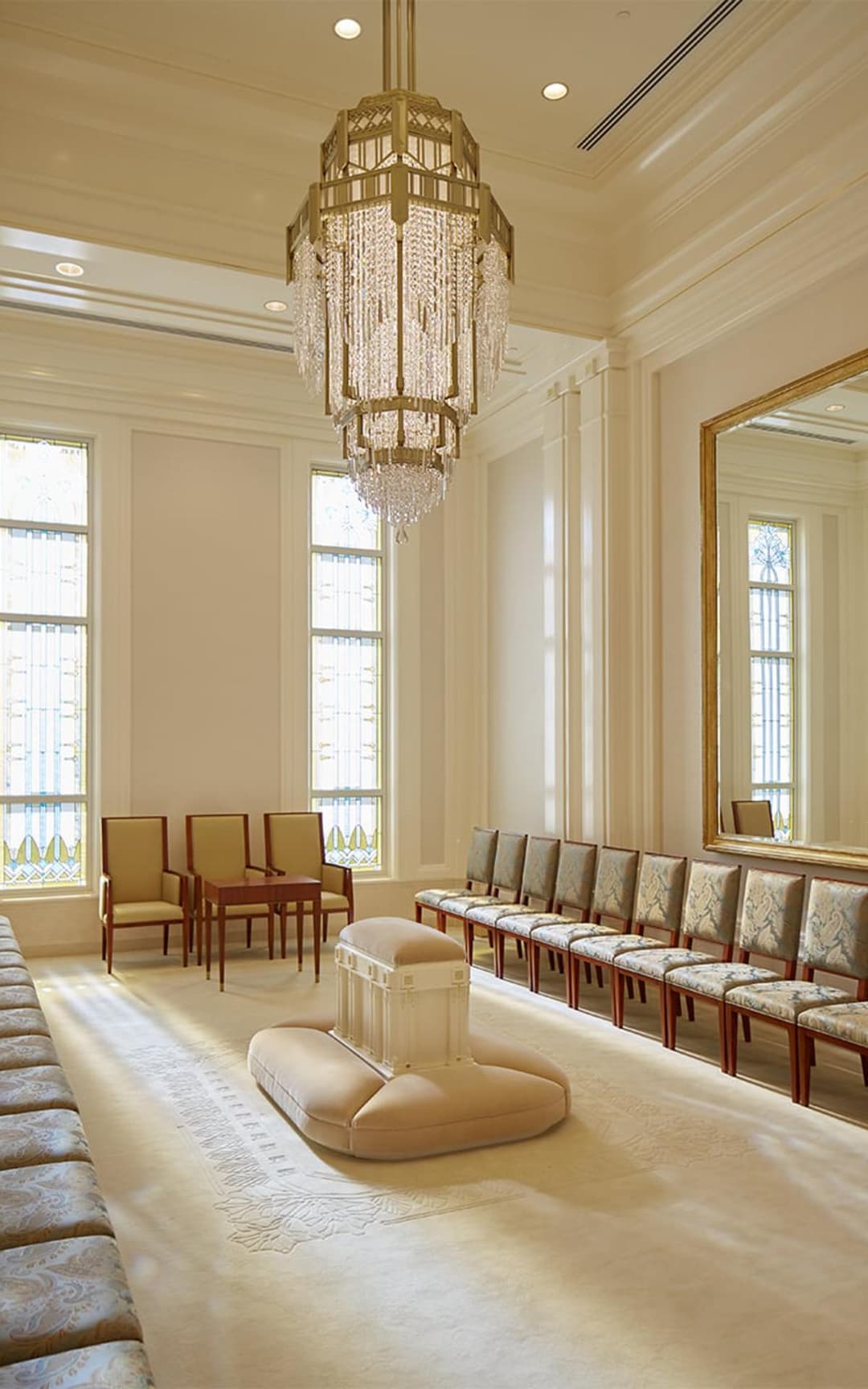 Meridian Idaho Temple interior with grand chandelier, seating, and decorative windows.