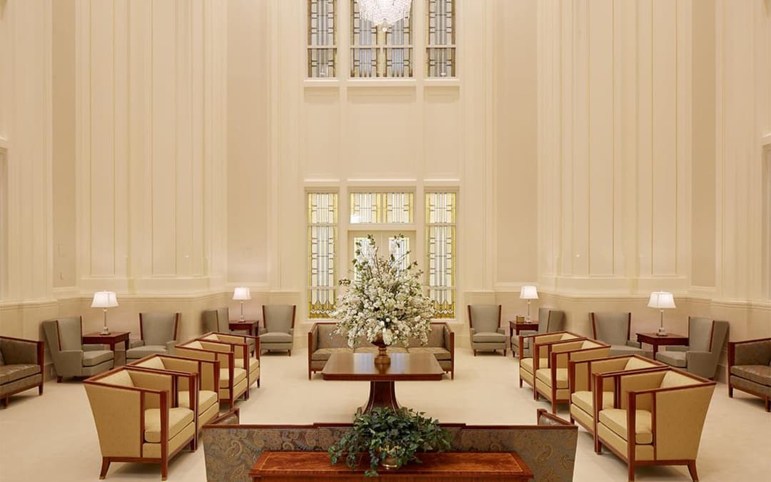Meridian Idaho Temple interior: elegant waiting area with seating and floral display.