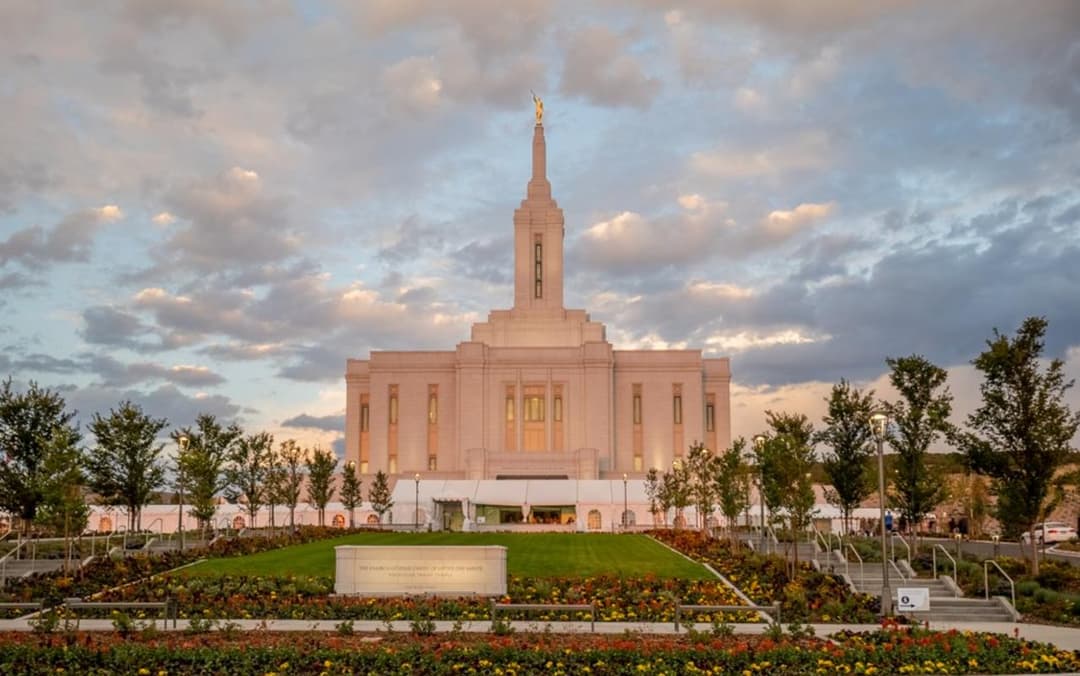 Front exterior view of the Pocatello Idaho Temple and grounds at dusk.