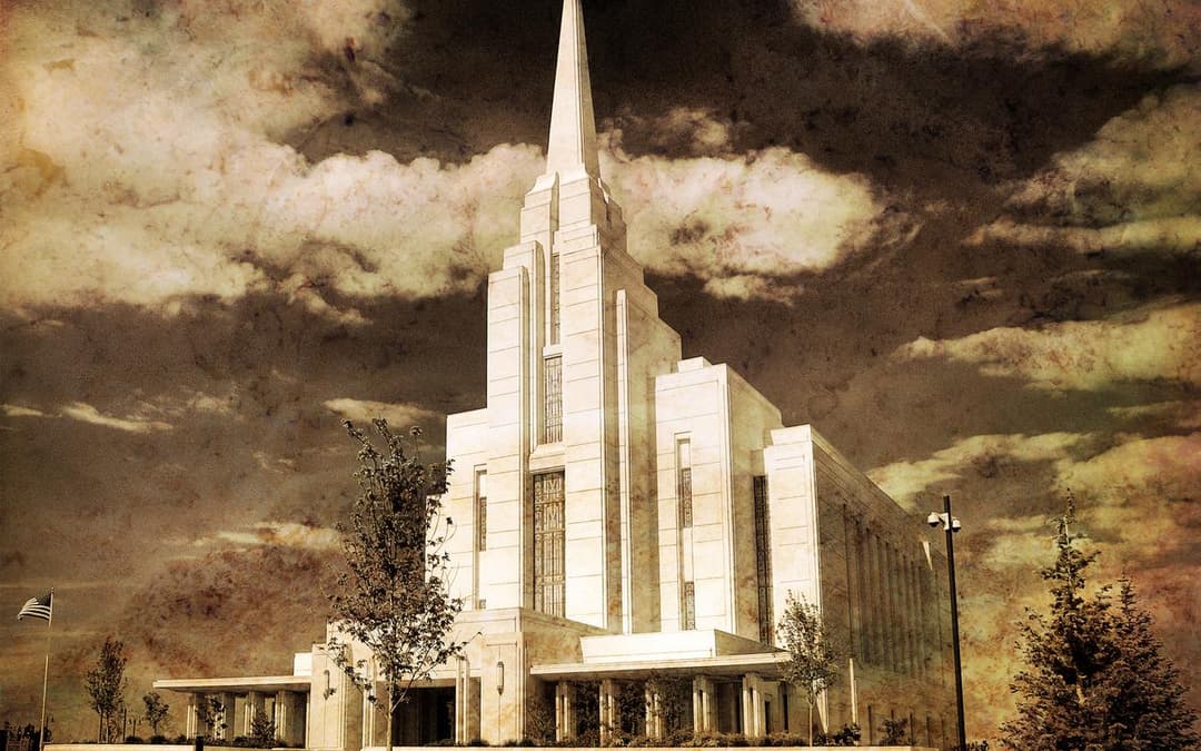 Rexburg Idaho Temple exterior, central spire, under a cloudy, textured sky.