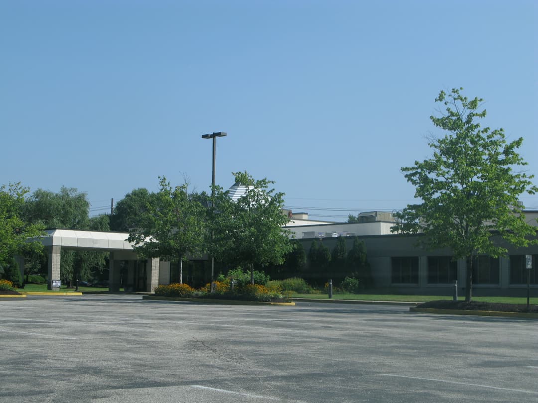 Daytime view of the covered entrance and parking lot