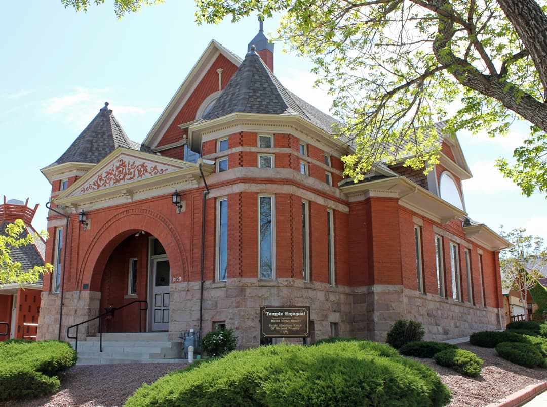 Exterior view of the arched entryway and conical turrets in daylight