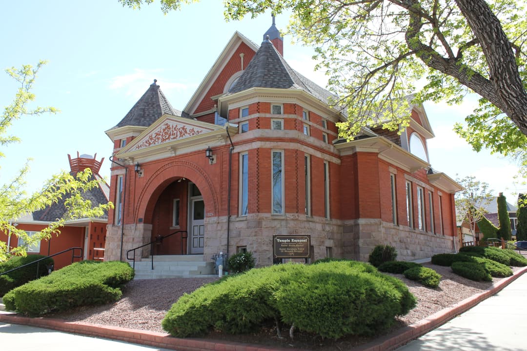 Front-angle exterior view showing the arched entrance and turrets.