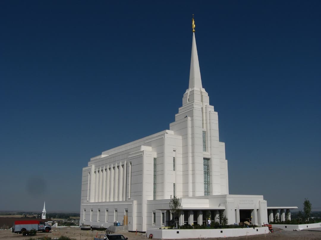 Teton River Idaho Temple, wide view of white building, spire, and golden Angel Moroni.
