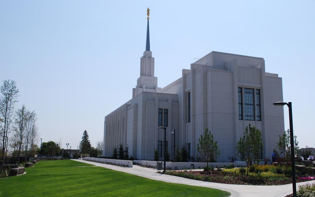 Exterior view of the Twin Falls Idaho Temple spire and manicured grounds.