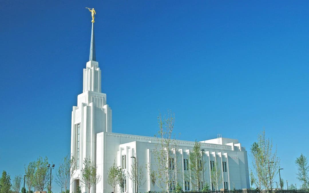 Exterior view of the Twin Falls Idaho Temple spire against a clear blue sky.