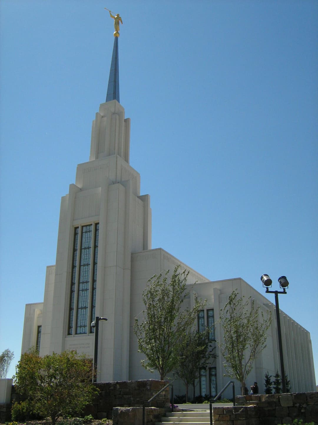 Low-angle view of the exterior facade and spire in bright sunlight.