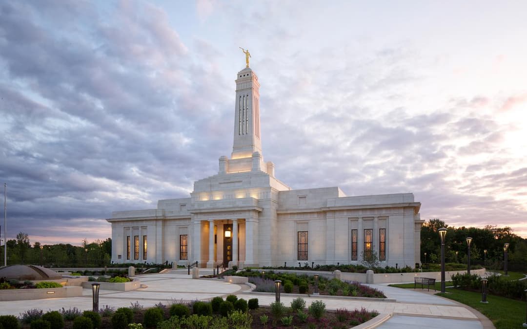 Indianapolis Indiana Temple at twilight, front entrance, spire, and gardens.