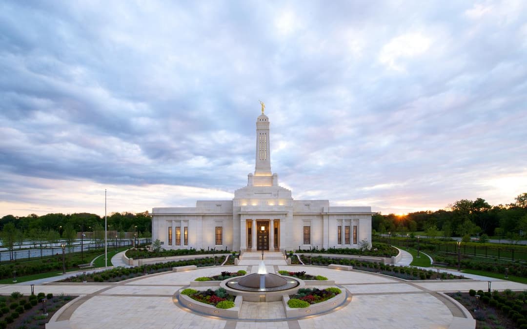 Indianapolis Indiana Temple at twilight, front view with spire and fountain.