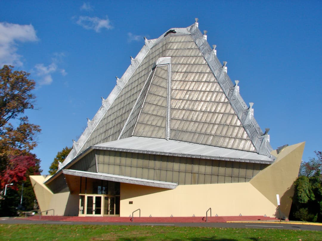 Exterior view of the pyramidal glass tower and entrance pavilion