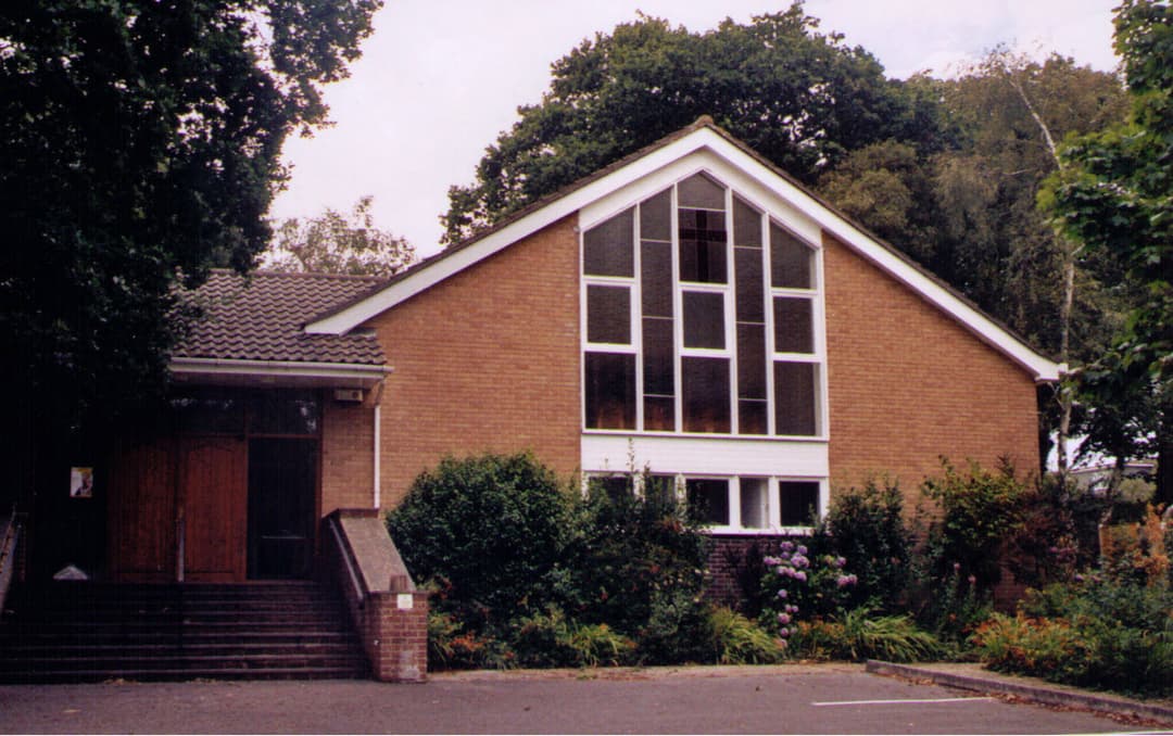 Front facade featuring large multi-pane window and entrance stairs