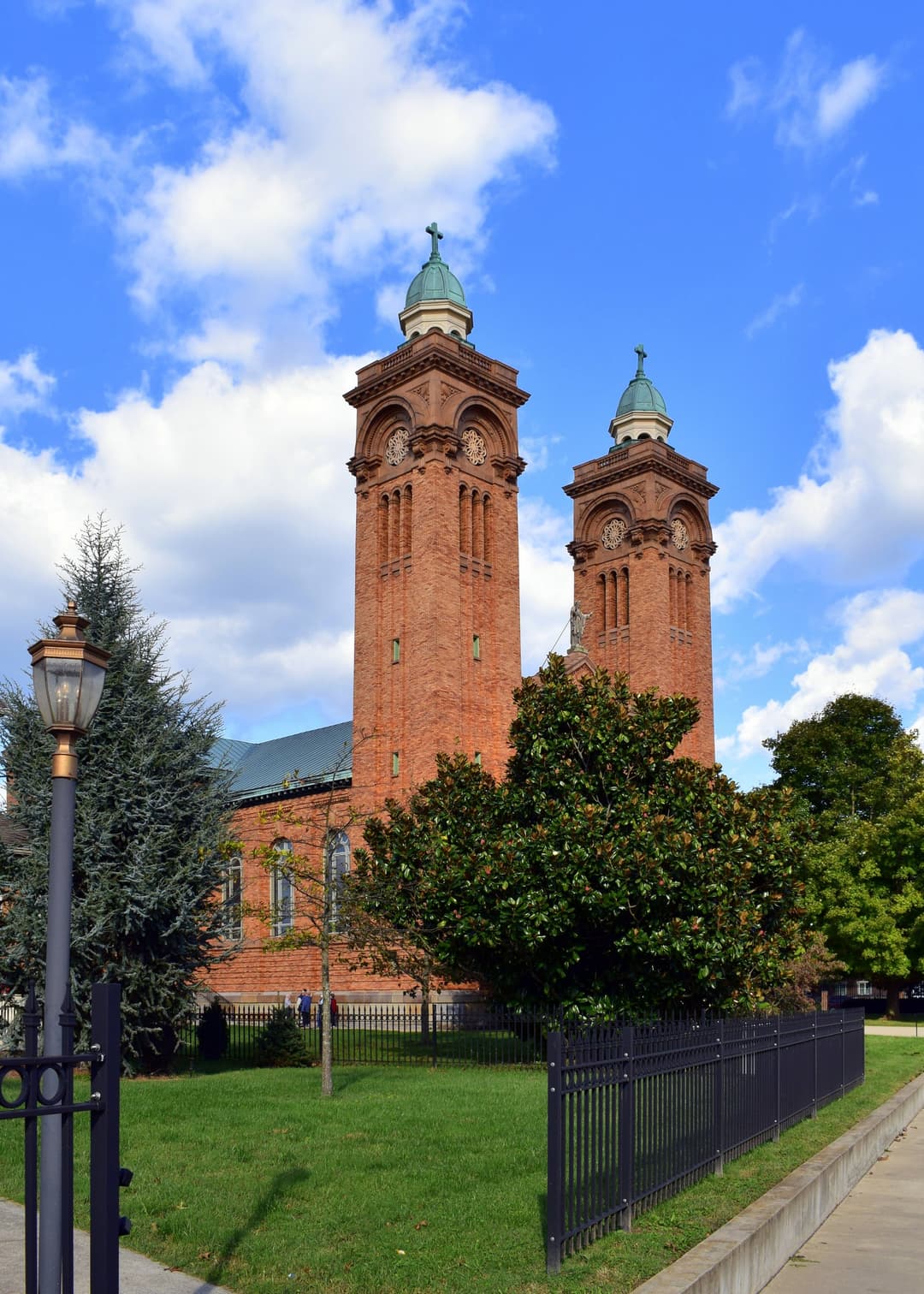 Daytime exterior view of the twin brick towers with copper cupolas