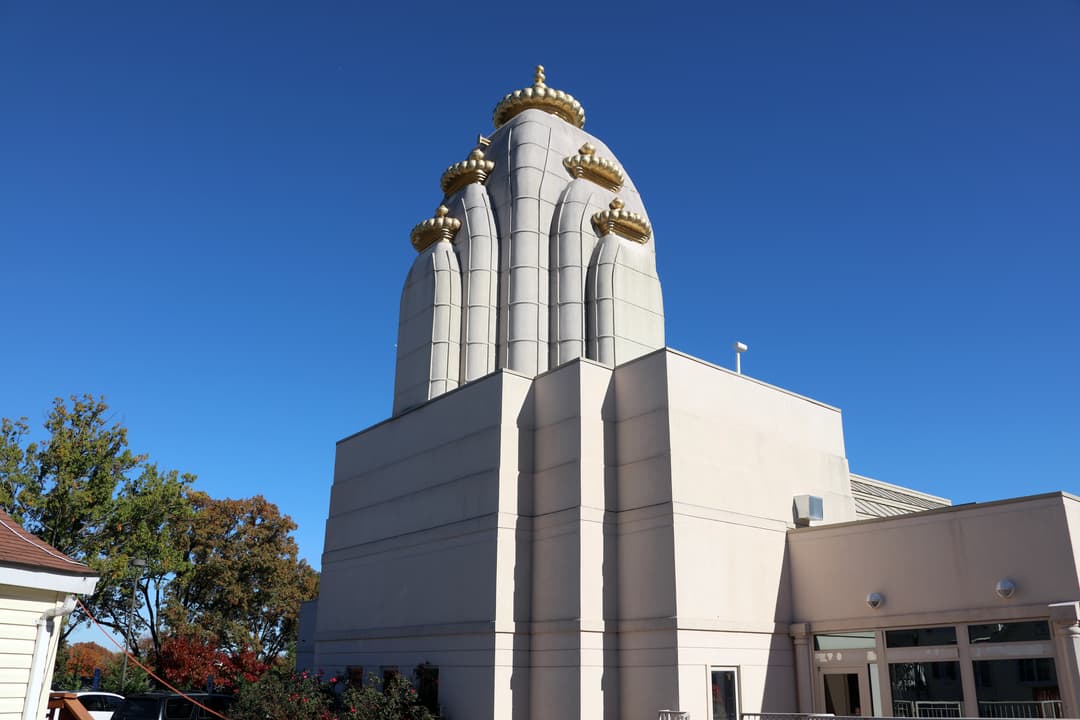 Low-angle daylight view of the central spire adorned with golden finials.