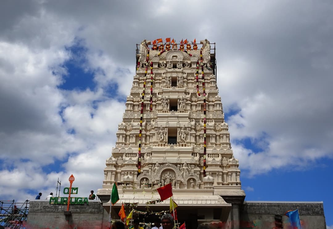Low-angle view of the ornate Dravidian Rajagopuram entrance tower.