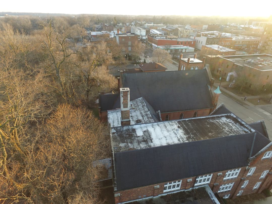 Aerial view of the church complex rooftops at golden hour