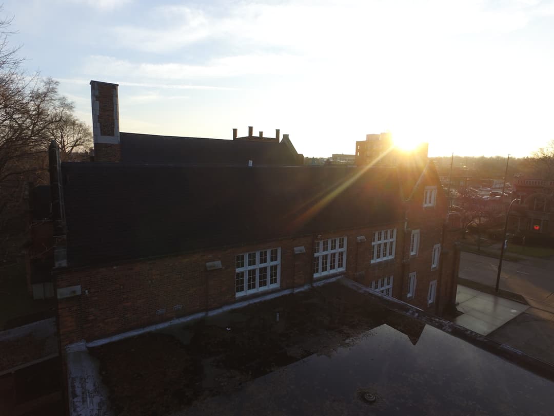 Elevated view of the brick roofline at sunset