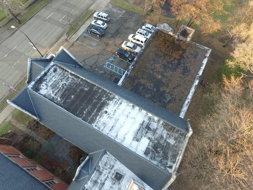 Overhead aerial view of the church rooftops and adjacent parking lot