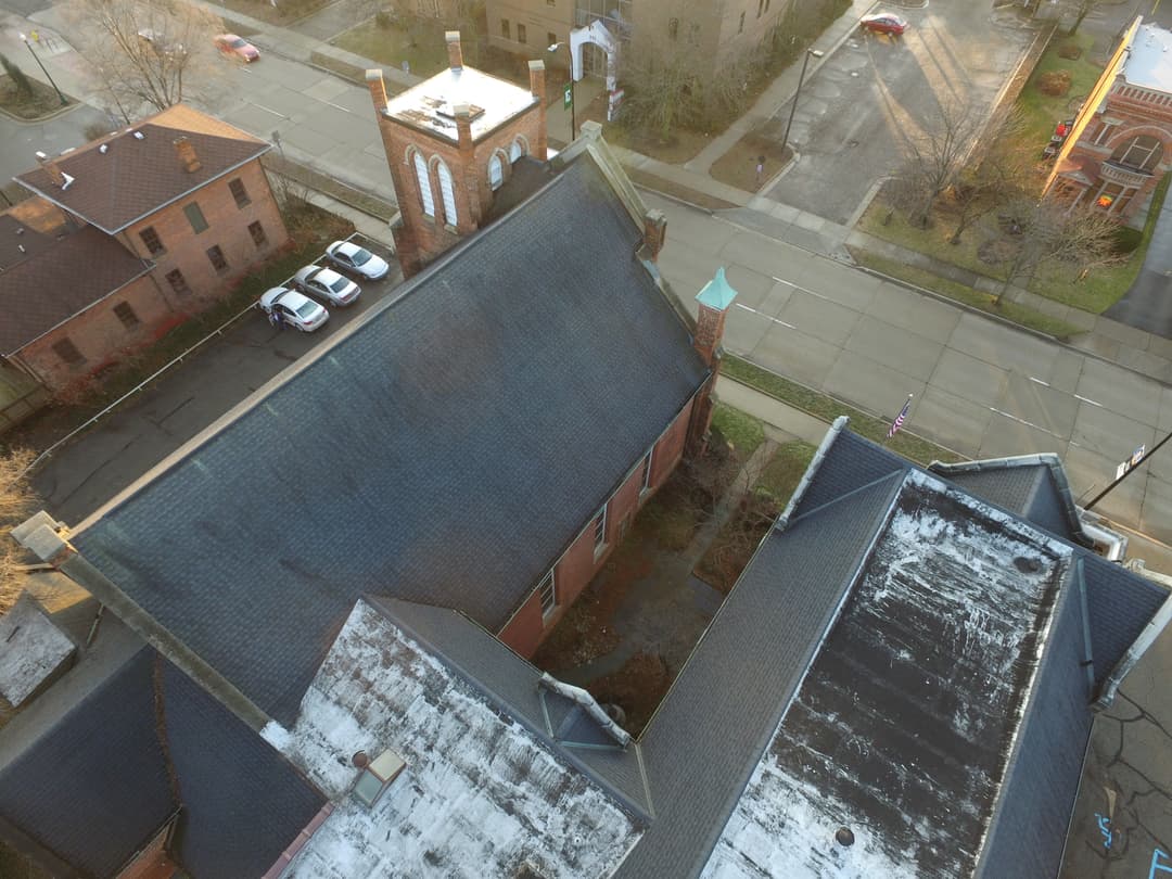 Aerial bird's-eye view of church roofs and bell tower