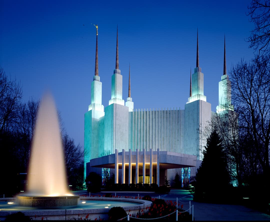 Washington D.C. Temple at twilight with illuminated fountain and spires.