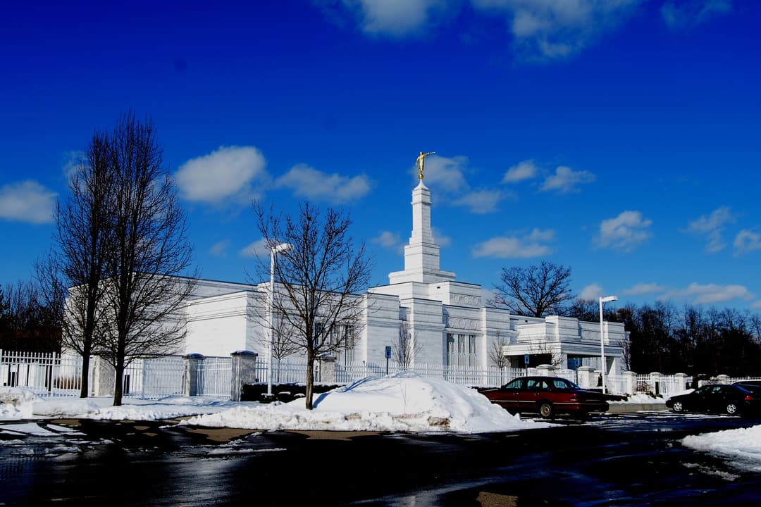 Daytime exterior of Detroit Michigan Temple in winter, with Moroni statue.
