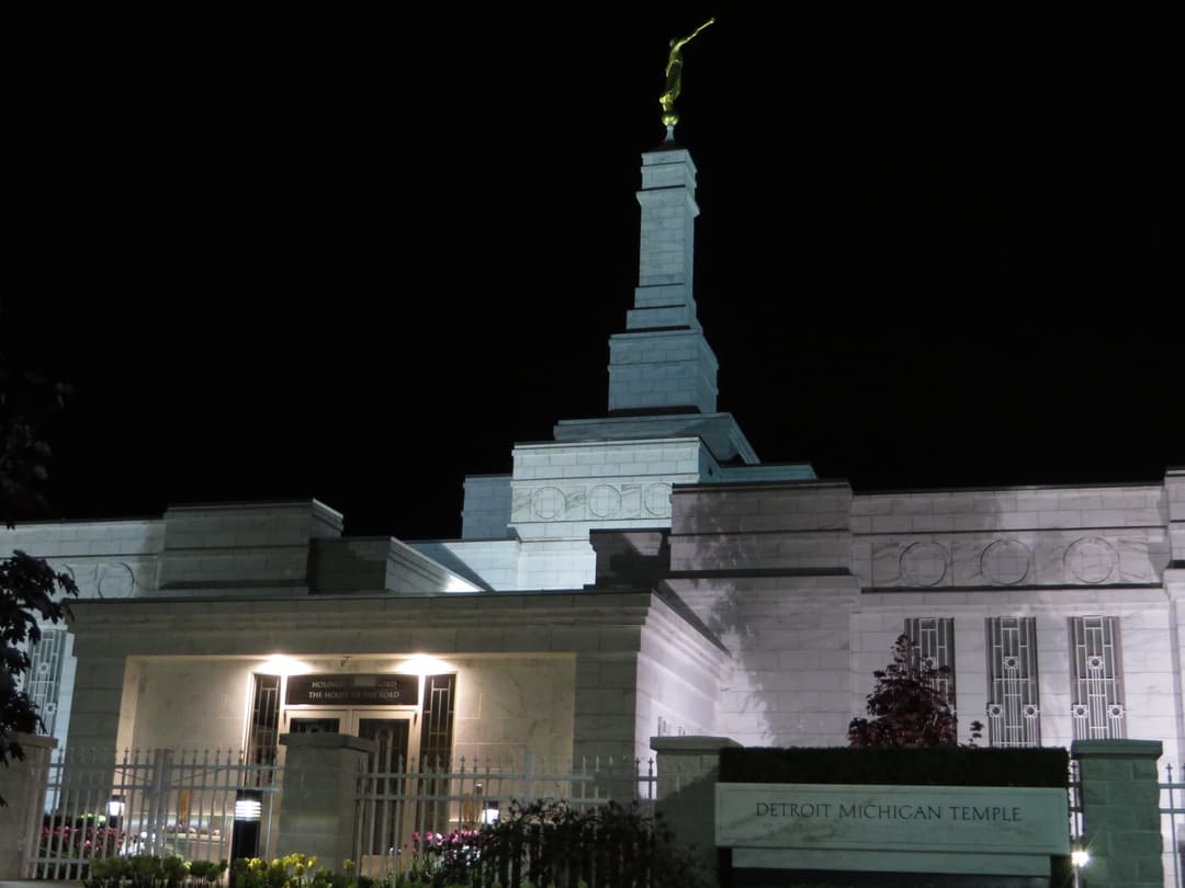 Night view of Detroit Michigan Temple, front entrance, spire, and Angel Moroni.