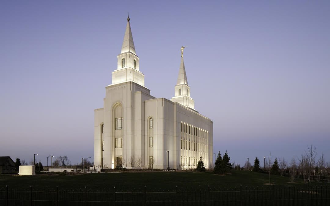 Kansas City Missouri Temple at dusk, two illuminated spires.