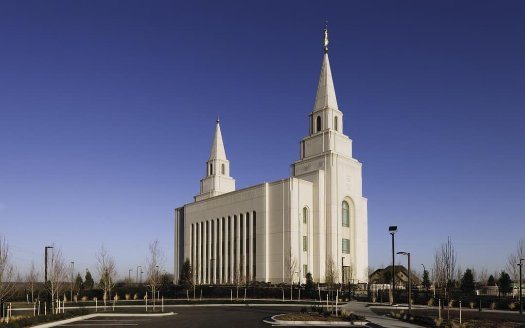 Kansas City Missouri Temple exterior, two spires, golden Moroni, clear day.