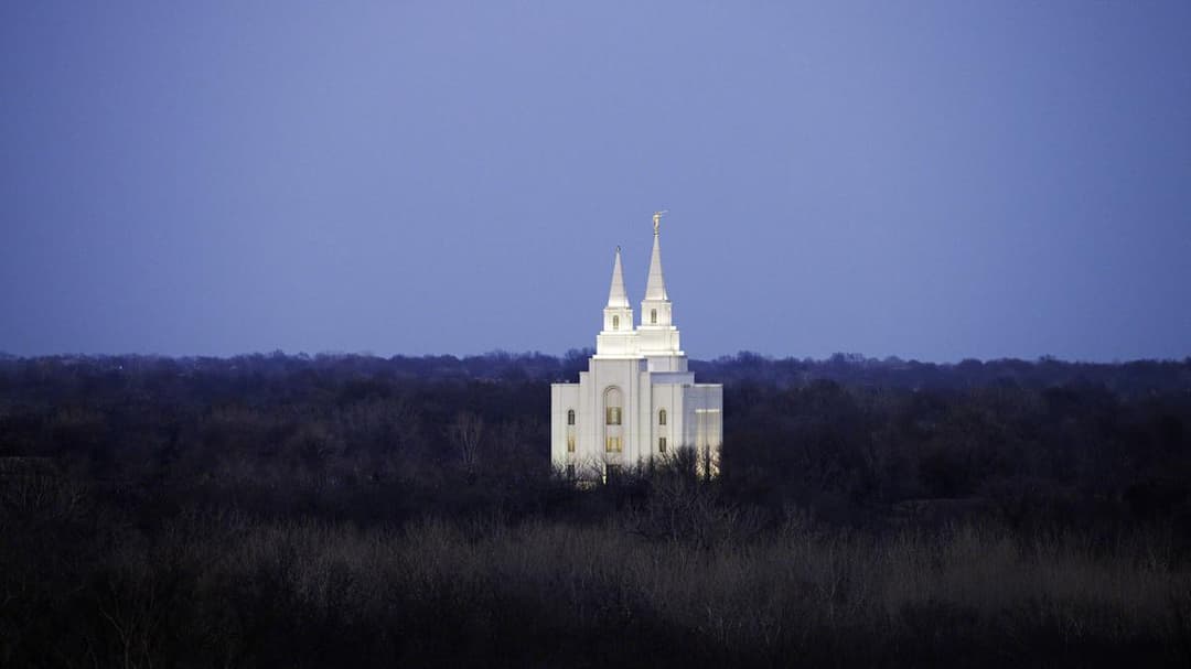 Kansas City Missouri Temple at twilight, two spires, Angel Moroni.