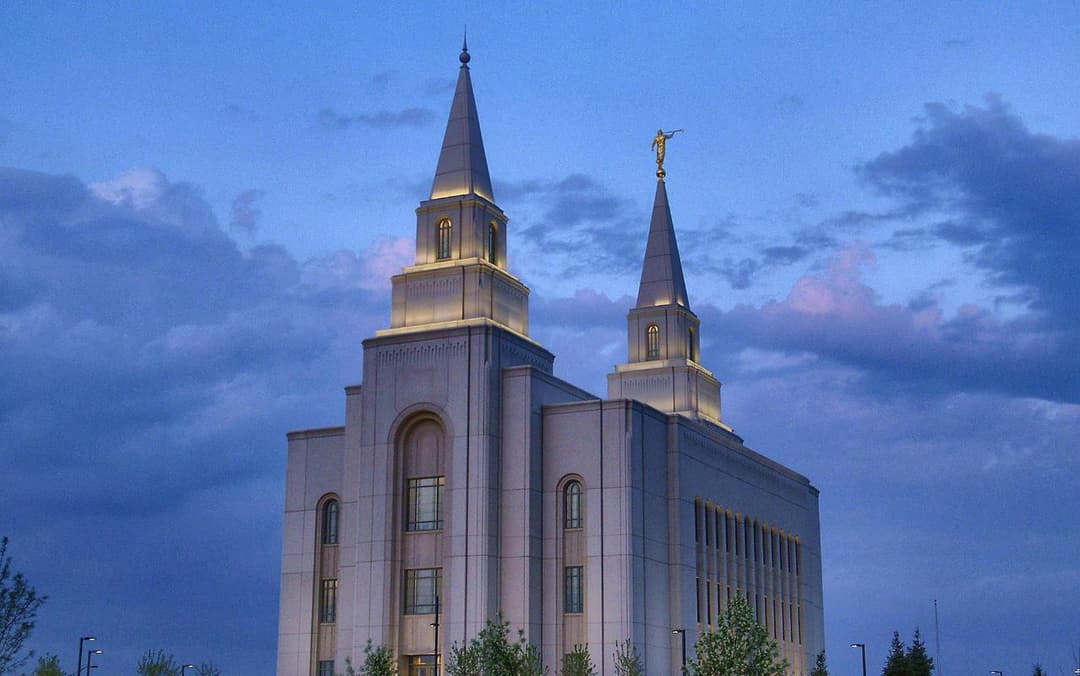 Kansas City Missouri Temple at twilight, featuring its two illuminated spires.