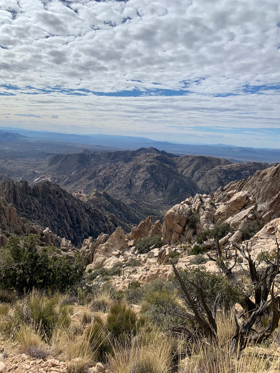 High-angle view of rugged granite peaks overlooking the vast desert basin.