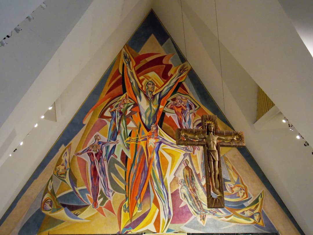 Interior view of the sanctuary mural and suspended crucifix.