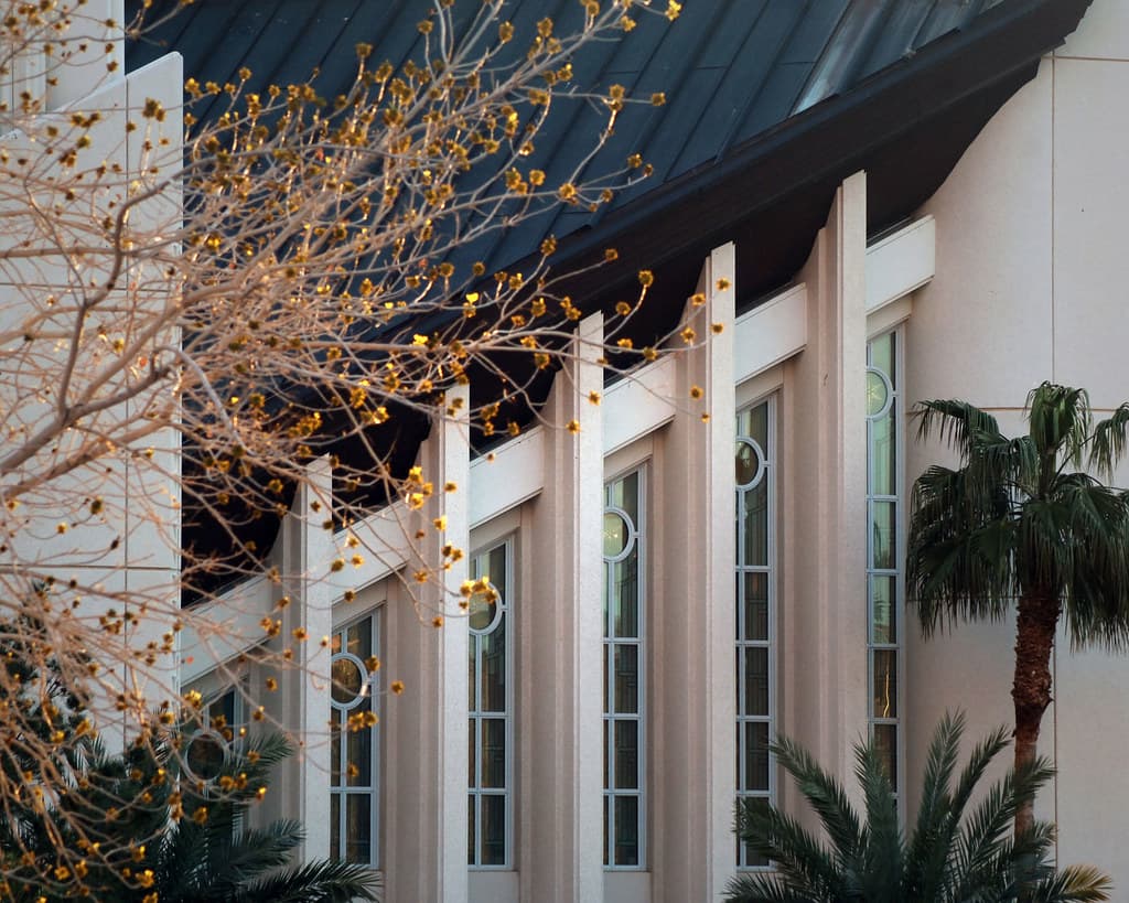 Close-up of the Las Vegas Temple facade, with sloped roof and vertical windows.