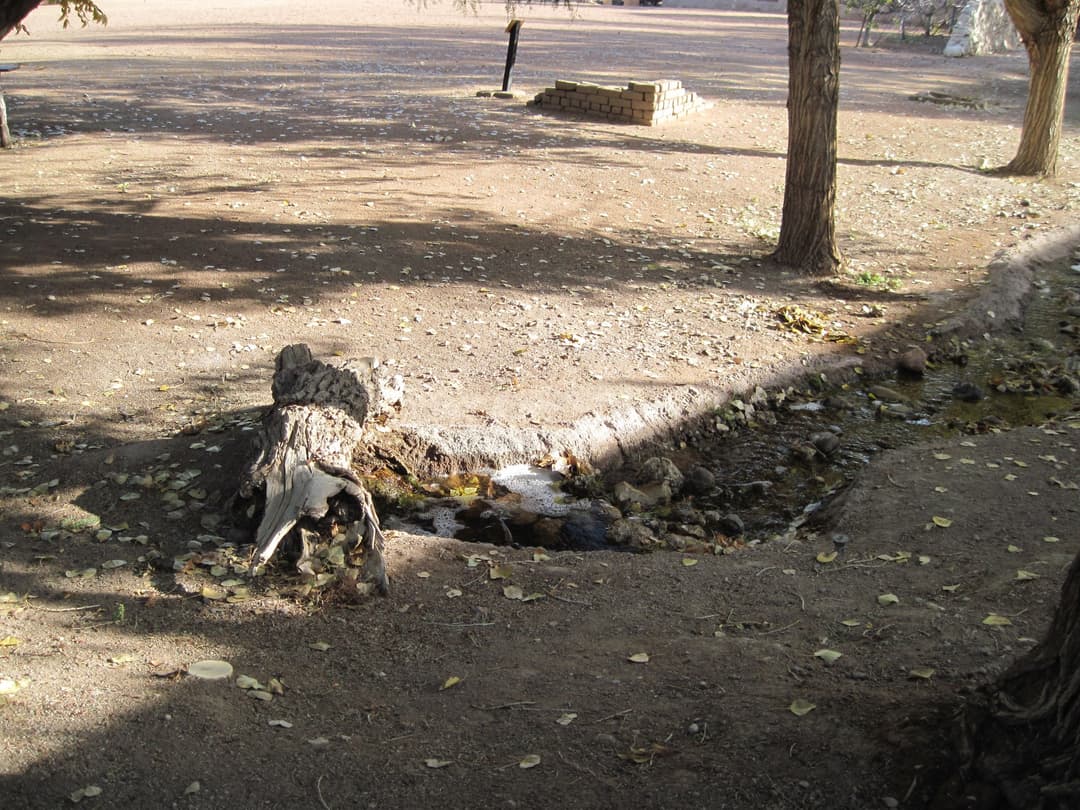 Small irrigation stream flowing through the shaded grounds of the fort.